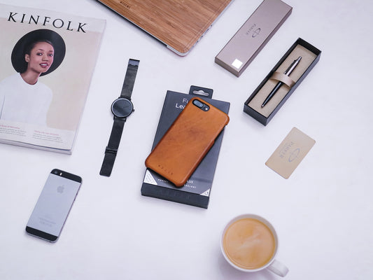 silver iphone 6 beside black watch and silver iphone 6