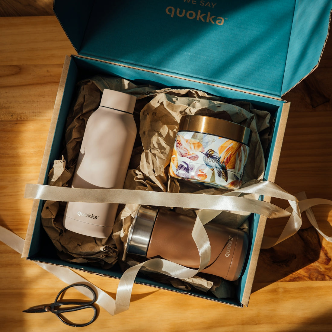 a box with a bag and a pair of scissors in it