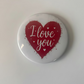 Button badge with red heart and 'I love you' text on a white background