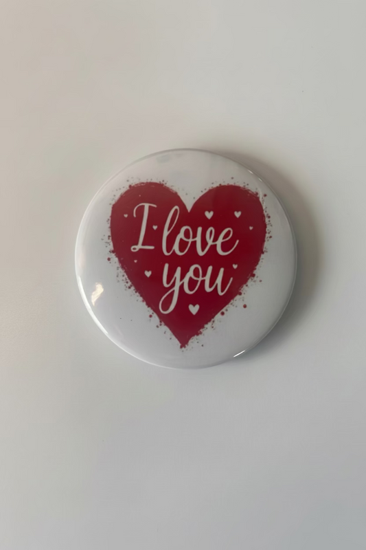 Button badge with red heart and 'I love you' text on a white background